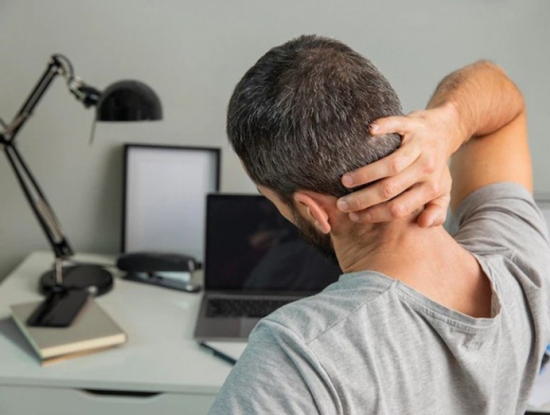 back view man stretching while working from home 23 2148806667